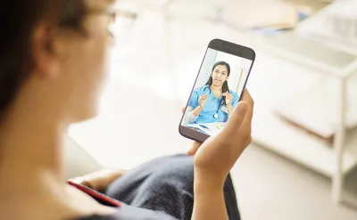 Patient speaking with her doctor using a smartphone