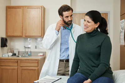 Woman discussing heart disease with her doctor