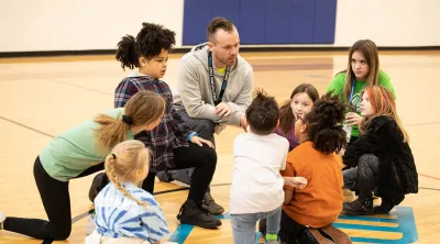 Coach with kids at the Boys & Girls Club of America