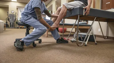 Doctor assisting a patient with physical therapy