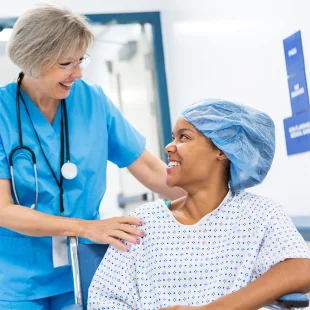 Clinician assisting a patient in a hospital