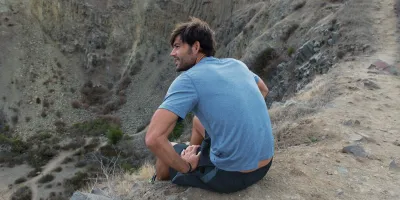 Man sitting at a canyon
