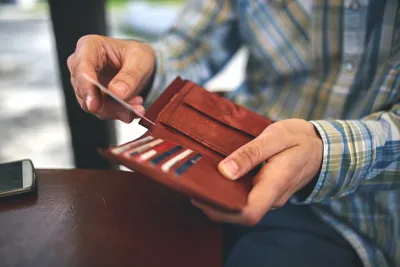Hand taking something out of a wallet