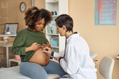 Pregnant woman being cared for by her doctor