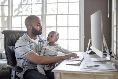 A father with his child accesses his health data online