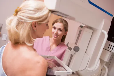 A nurse performing a breast cancer exam