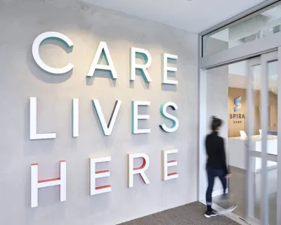Interior of Spira Care center; wall reads "Care Lives Here"