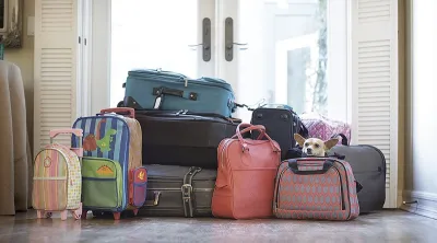 Expat family's suitcases packed, waiting at the door for travel back to the United States