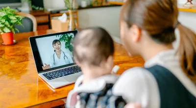 Mom and baby using free telehealth services from Blue KC