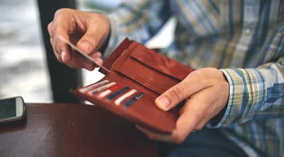 Hand taking something out of a wallet