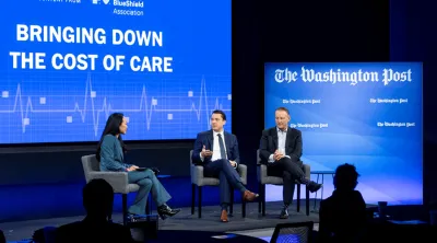 Three people on stage at a healthcare conference