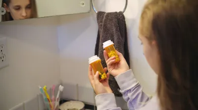 Pharmacist looking at pill bottles