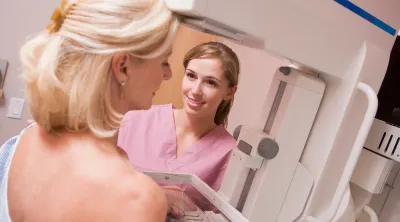 A nurse performing a breast cancer exam