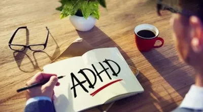 Person reading a book with ADHD in large print