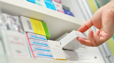 Pharmacist opening a drawer of pharmaceuticals