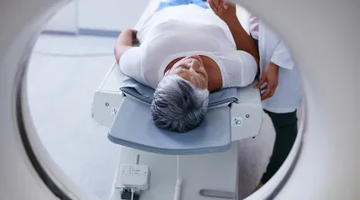 man on MRI table in front of MRI machine