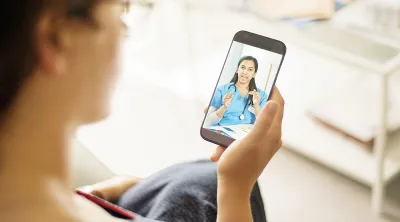 Patient speaking with her doctor using a smartphone