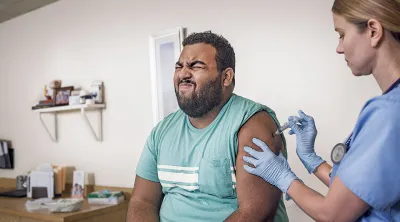 Nurse giving Blue Cross Blue Shield member a flu shot