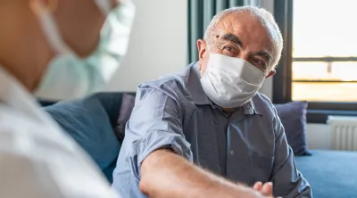 Senior wearing mask with a Doctor
