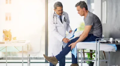 Doctor checking Patients Knee