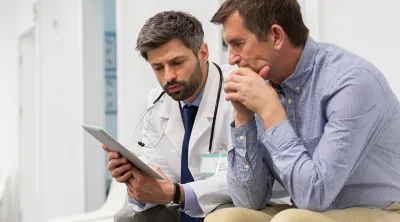 A doctor and patient reading colorectal cancer information