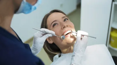 Woman getting her teeth cleaned at the dentist's office