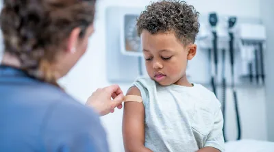 Young boy receiving a vaccination from a doctor