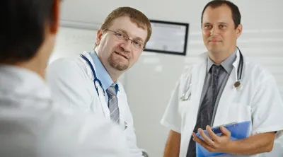 Two doctors discussing their diagnosis with a patient