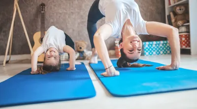 Family doing yoga exercises at home