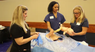Nurses run an emergency pregnancy simulation.